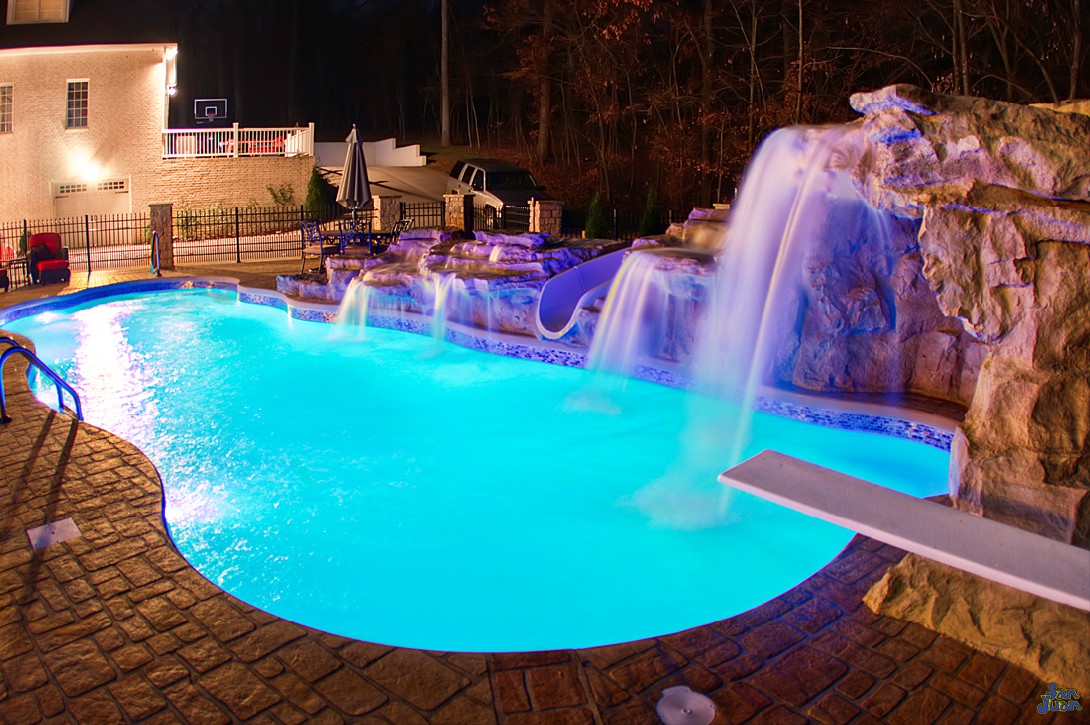 inground fiberglass pool with amazing water features