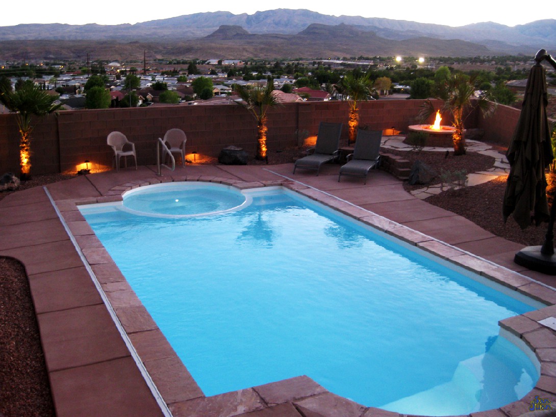 ceasars palace fiberglass pool shape with fire pit and raised wall outside