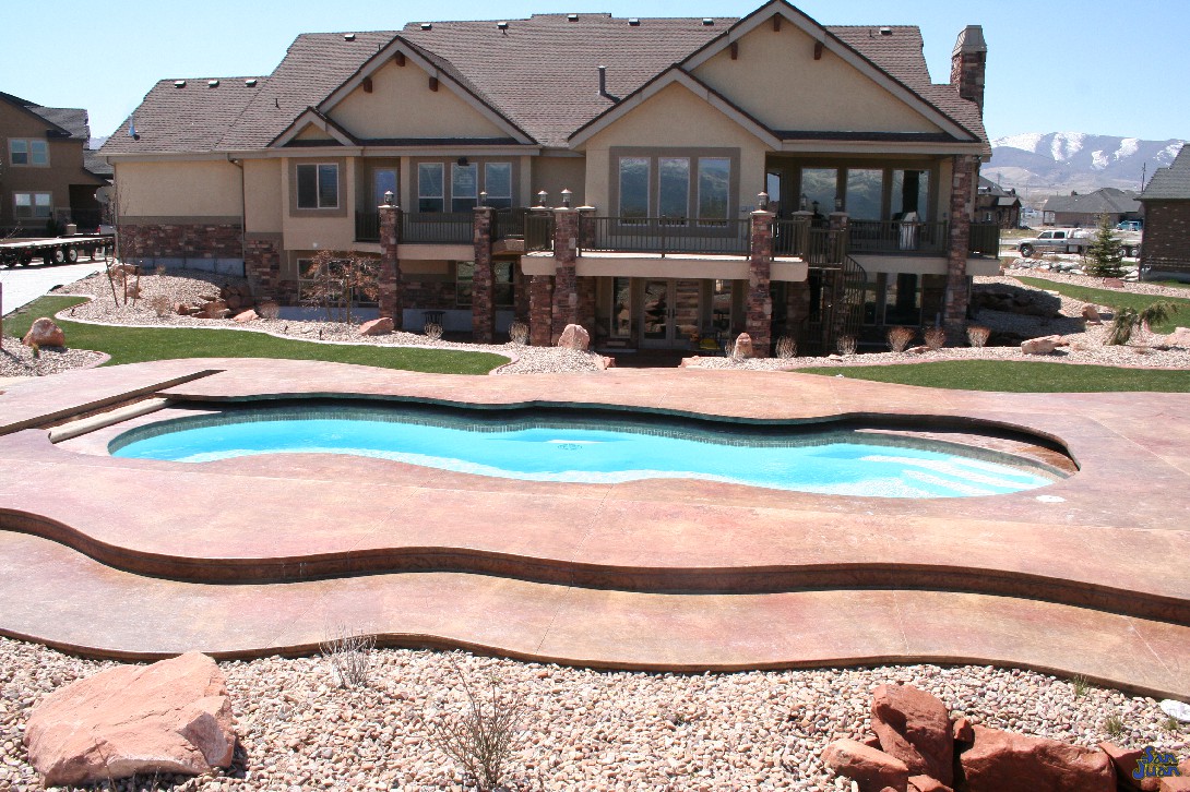 mirage pool shape at apartment complex with raised stamped concrete