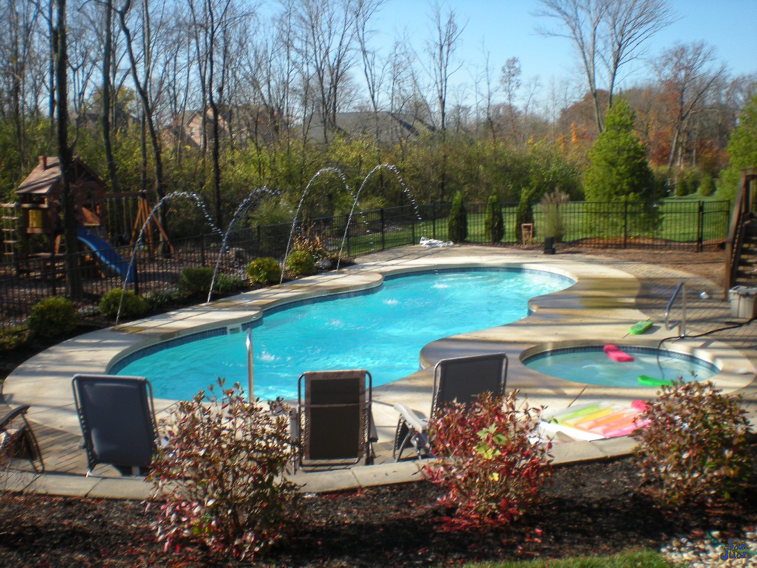 mirage pool shape in woods with spa and deck jets