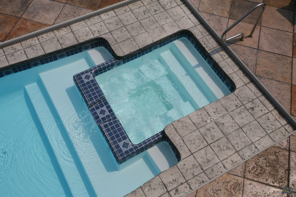 You can see the Olympus fiberglass pool outfitted with a tile liner across the rim of attached spa. There are many ways to spruce up this section of your fiberglass pool shell. We'll just leave the creativity up to you! 