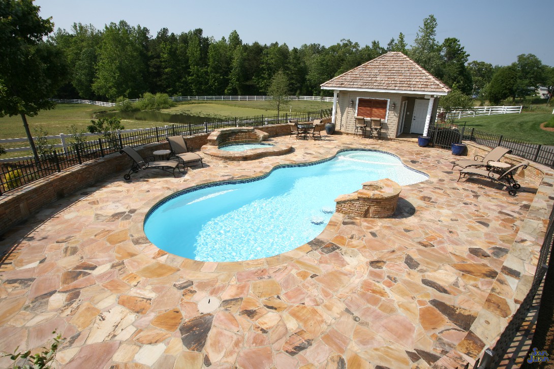 pleasure island fiberglass pool shape with natural travertine decking and outdoor kitchen (2)