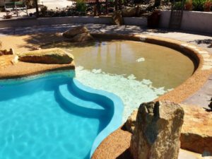 taj mahal fiberglass pool with beach entry and raised deck