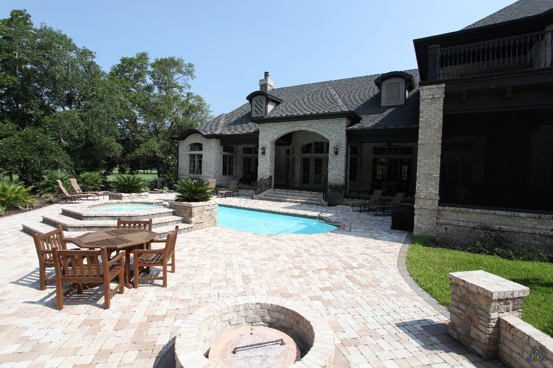 We'll give you one last sneak peak of what could be. This backyard includes gorgeous brick pavers, a fire pit next to a family dining area, raised spa and gorgeous landscaping. With a home like this - you've got a new meaning for Stay-cation!