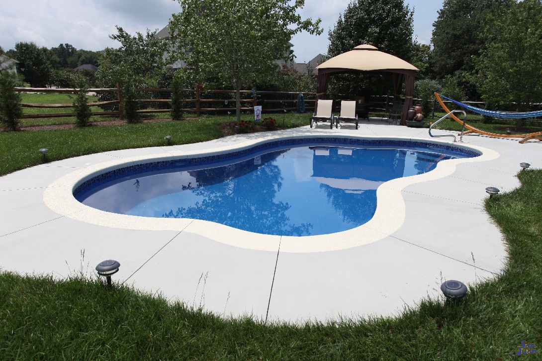 Here is one last look at our beautiful Rio fiberglass swimming pool. This pool fits perfectly in small backyards and pairs very well with add-on items to create a whole new look! Adding in some pool furniture and umbrella creates a perfect area to lay out and relax during the warm days of summer!