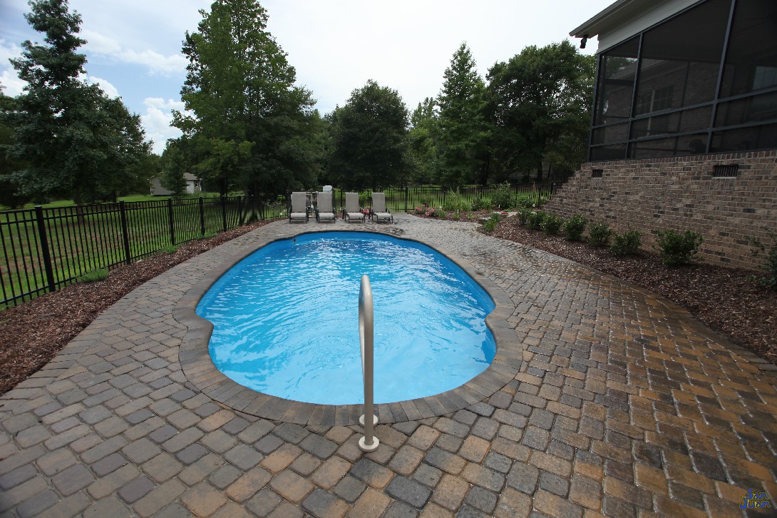 This image shows a Pompano Beach fiberglass shell outfitted with a brick paver deck &amp; outdoor furniture. This is definitely a relaxing space and a perfect way to escape from the hot Texas heat!