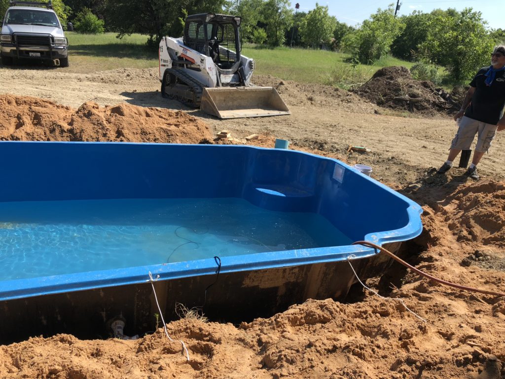 We over dig our pool shell by 12"-24". This leaves our crews plenty of room to get beneath the structure and plumb our return lines & lighting. 