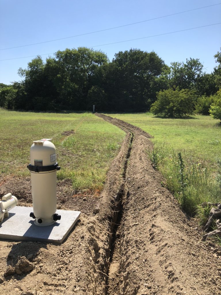 We are capable of working in all shapes and sizes of backyard spaces. This swimming pool in particular had a run of over 100 feet from our electrical supply to the swimming pool. In order to provide proper protection of our electrical components, we are trenching and running conduit from our pool shell to the electrical station. 