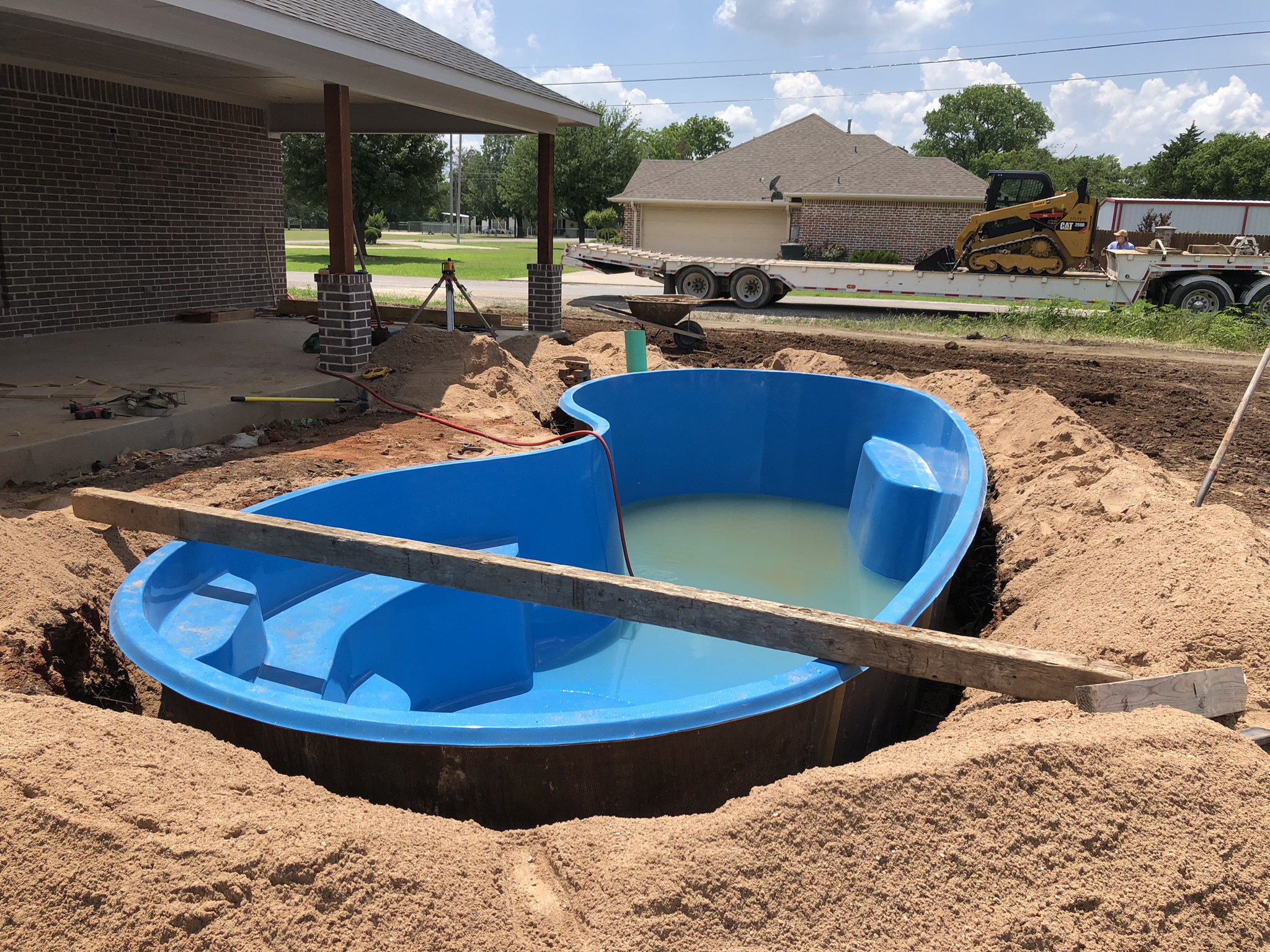 It ain't pretty right now but it will be once we're done! This image shows a beautiful Seaside Fiberglass Pool shell being installed in Tioga, TX. This home was recently built and the home owner hasn't even moved in yet. We are completing the installation of this beautiful pool and by the time the moving boxes arrive, they will be ready to take a cold plunge in their gorgeous fiberglass pool!