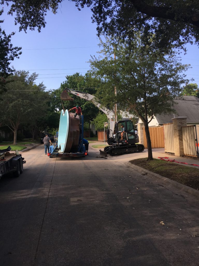 Kids, don't try this at home. Here you can see our San Juan delivery truck with our excavator. Aren't they working nicely together and exercising their team working abilities? In fact, these swimming pools require a large amount of coordination to safely offload, carry and set into the earth. It's another reason why you should trust Fiberglass Pool Guyz with your swimming pool investment. We take the time necessary to perform all of our operations safely and efficiently!