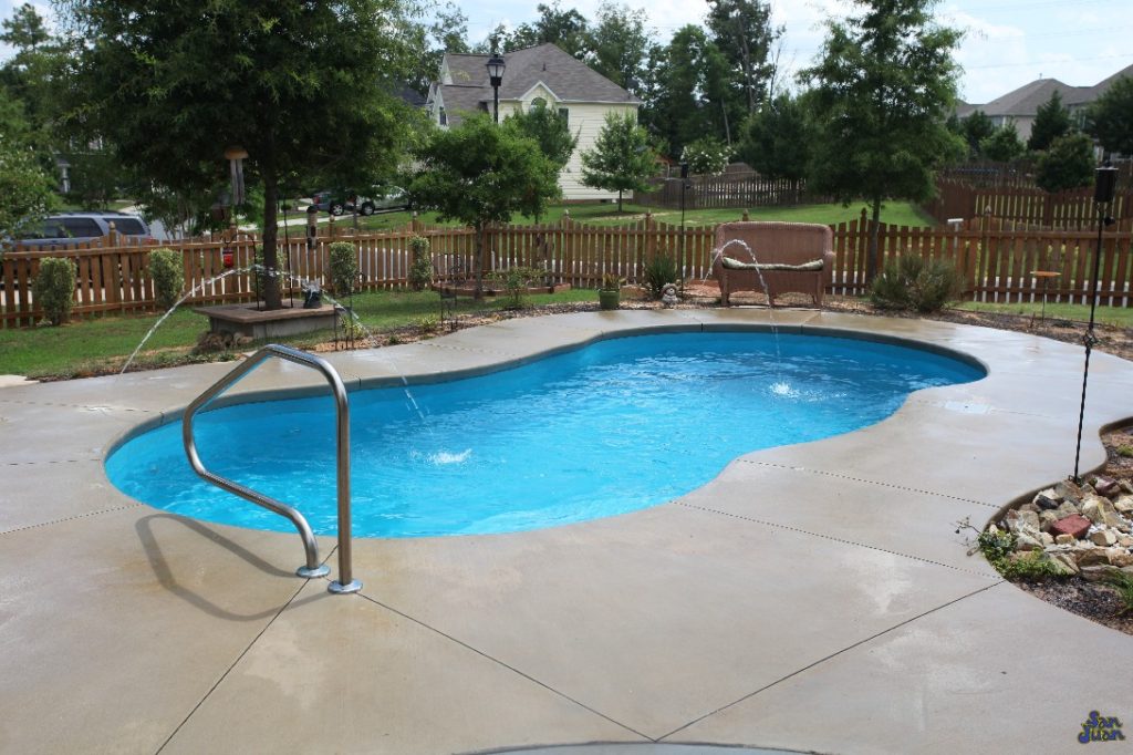 Here you can see the Lelani tucked away into a beautiful backyard landscape. This home owner has dressed up their Lelani with a complimentary pair of deck jets & figure-4 handrail. We recommend sprucing up your fiberglass swimming pool with these fun features. It's a great way to enhance your outdoor entertainment space!