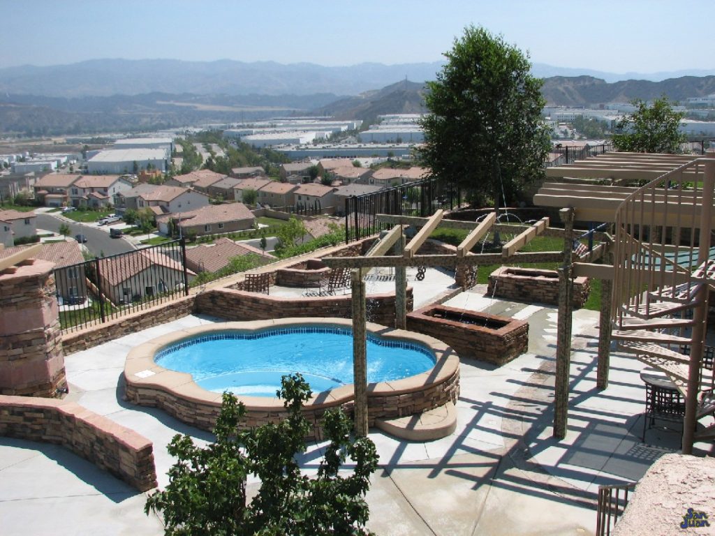 Here is a great overview image of the Crystal Springs. We love this fiberglass pool & spa combo because it leaves us with so much left over in your backyard. This allows us the opportunity to create a unique layout. Here we can see this client selected a pergola, concrete pool deck, landscaping and patio furniture. Now that's a complete outdoor living space!