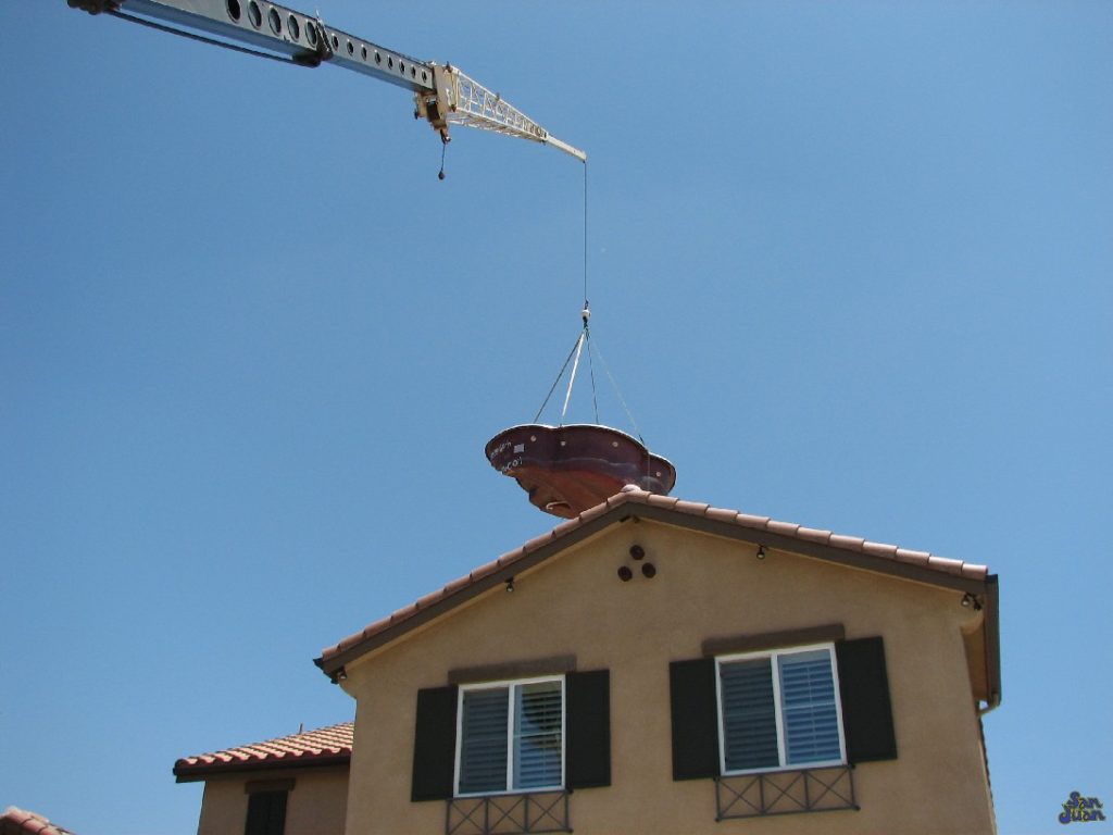 Did you not believe us when we said we could install this pool nearly anywhere? Ever wonder how we do it? This picture is a perfect testimony of our ability to literally lift our products right over your house. Once hooked up to a crane, we can literally lift and lower our pool and spas right into your backyard! 