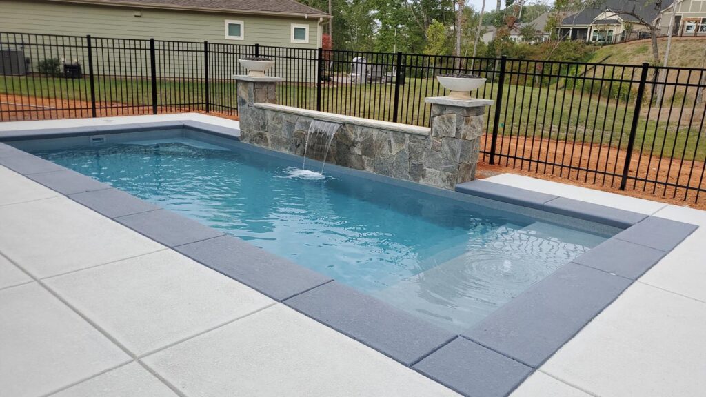 The Biloxi is a rectangular swimming pool with a modern design. Outfitted with a narrow tanning ledge that runs the width of the pool, this design is great for leisurely activities. Additionally, the flat bottom design makes this extremely comfortable with a maximum depth of only 4' 2.5". 